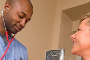 nurse taking blood pressure during a travel assignment after finding the right travel nurse agency for him