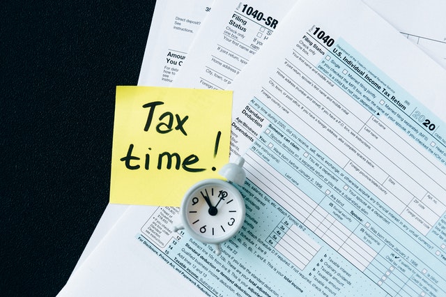tax documents saying "Tax time!" to remind travel nurse about tax season