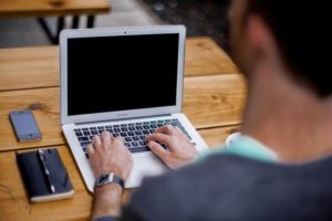 nurse on computer trying to find a travel nurse job close to home