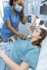 nurse helping patient after she was able to find a nursing job through AHS NurseStat