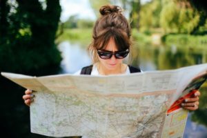 Nurse looking at map to choose her next destination with her national travel nursing agency