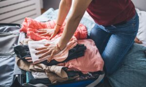 woman packing suitcase to find a travel nurse job