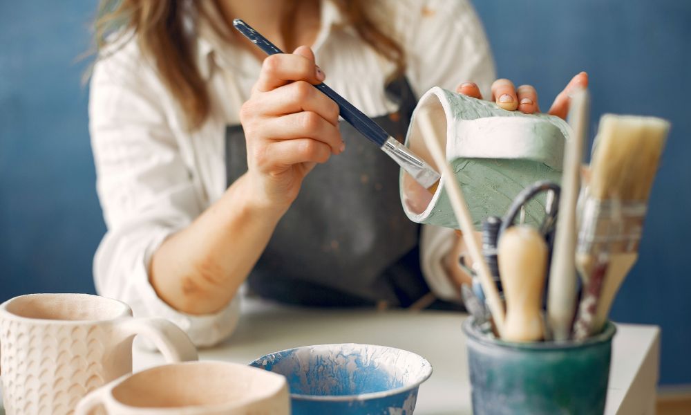 travel nurse relaxing by painting pottery