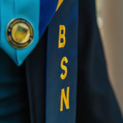 future travel nursing professional wearing BSN stoles for graduation